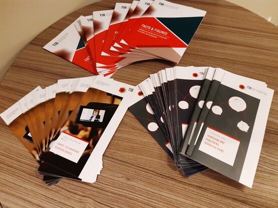 Pic shows three fanned out stacks of information flyers about 1) TIB Hannover 2) TIB AV-Portal and 3) TIB ConRec