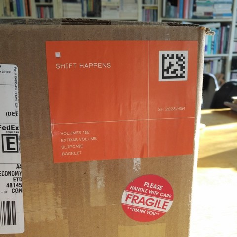 the parcel containing the book "shift happens", shown by a big orange sticker on one side