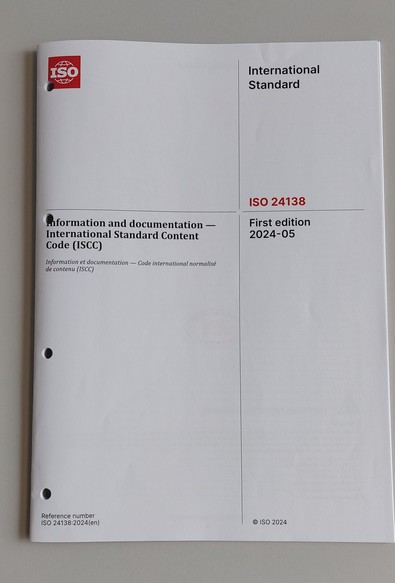 A photo of a plain white brochure of the ISO 24138 titled 