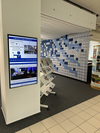 Foto des Eingangsbereichs der UB inklusive Servicebildschirm 