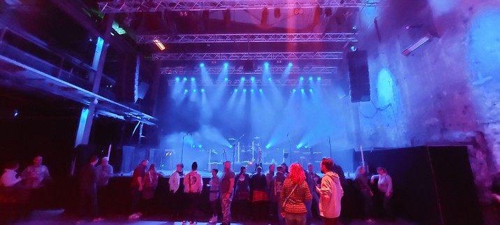 Photo of the empty stage. Blue lights around the stage.