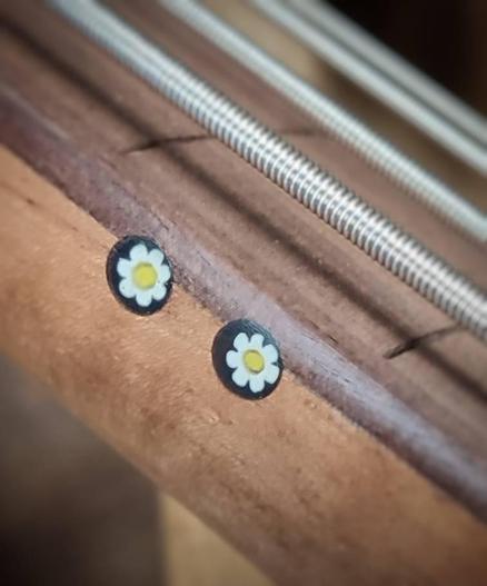 Detail of a bass guitar, actually build by Di Donato guitars, Venice. The foto shows the double side dots at the 12th fret, made from Murano glass. The neck is maple with a Pao Ferro fretboard already prepared for fretting. The instrument is strung with bass strings for testing reasons, but will still need another two months building time.