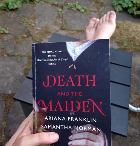 fotos des buches "death and the maiden" von ariana franklin und samantha norman auf einer gartenterrasse